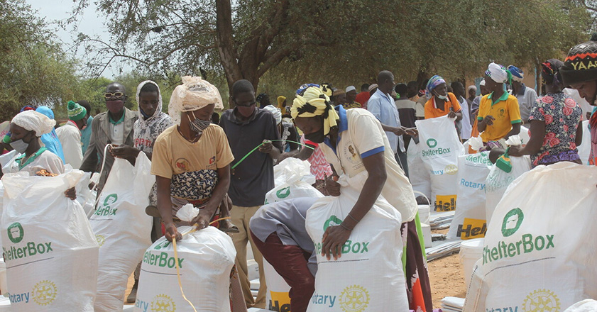 People collecting bags of aid in Burkina Faso