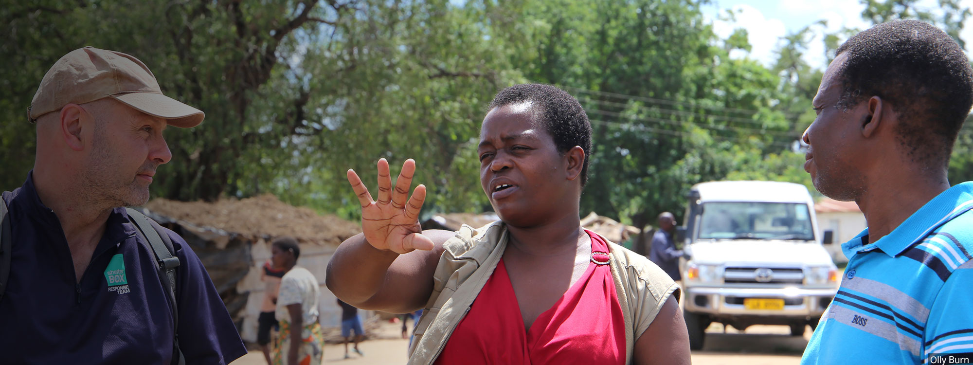 three humanitarians talking in malawi