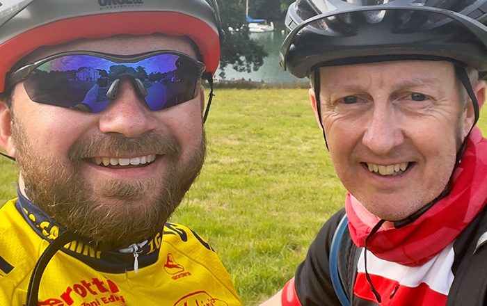 Two men wearing cycling helmets