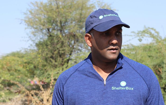 Man wearing blue top and cap