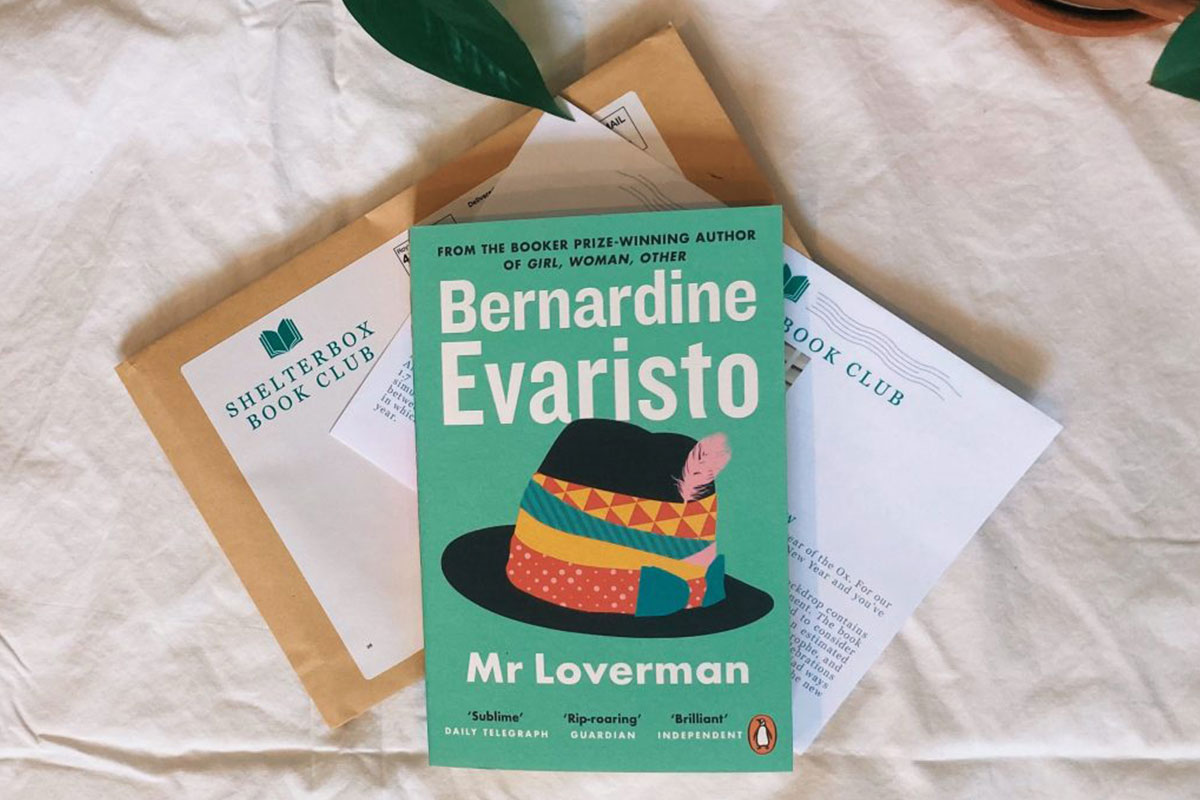 Image of book 'Mr Loverman' by Bernado Evaristo on top of a letter and envelope from the ShelterBox book club
