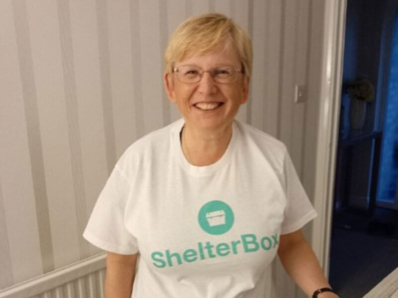 Female ShelterBox supporter in white ShelterBox tshirt