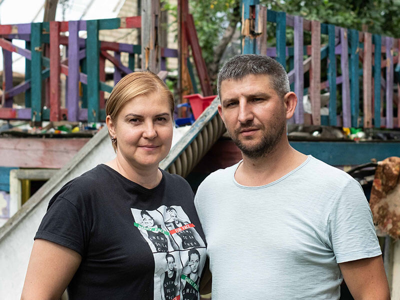 Ukrainian couple stand in front og a children's slide
