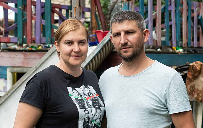 Ukrainian couple stand in front of a children's slide