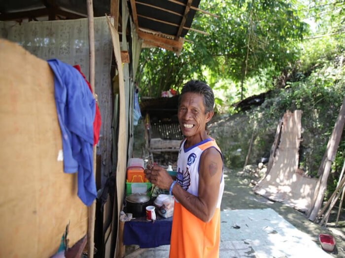Violeta's husband standing outside the family home in Cebu