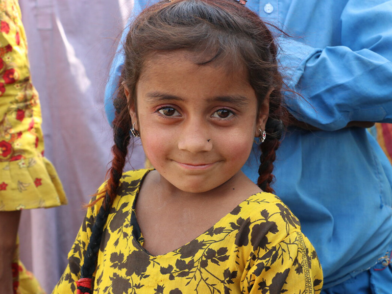 A young girl smiling at the camera