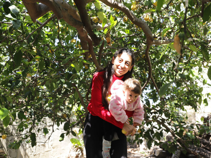 Woman holding a little girl under a tree in TUrkey