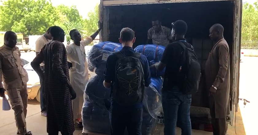 People unloading aid from a truck in Chad