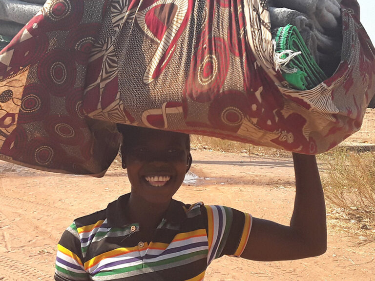 Lady with carrying large bundle on her head