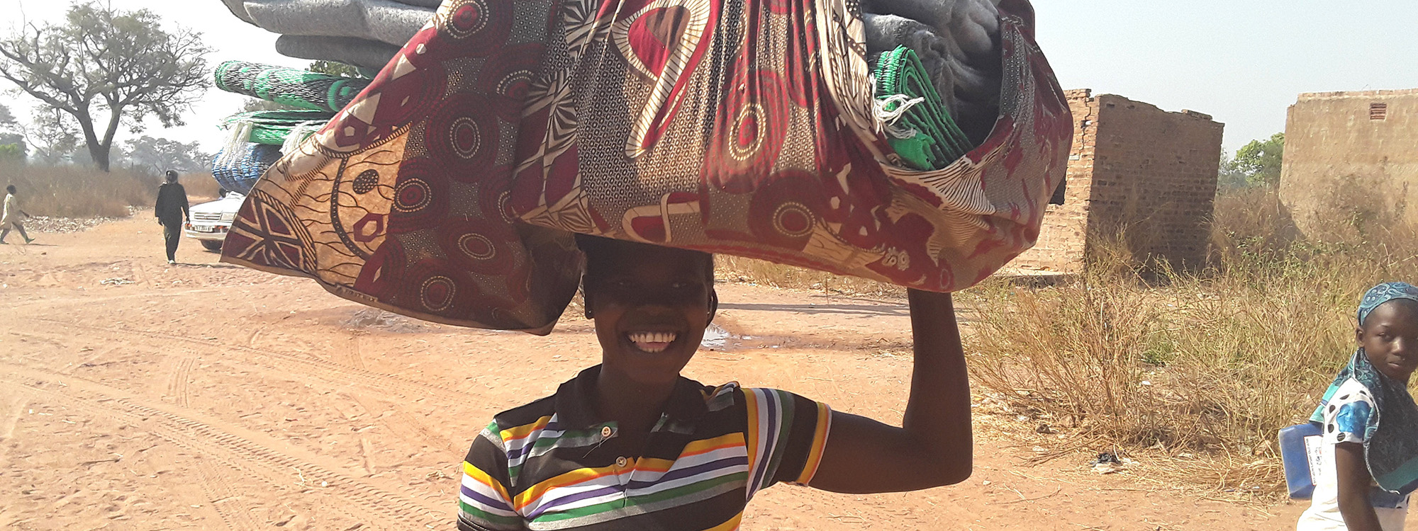 Lady with carrying large bundle on her head
