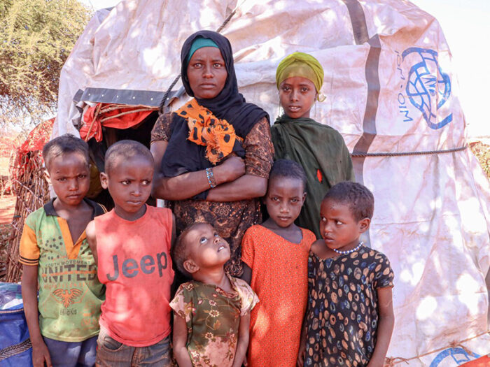 Woman and six children outside a shelter in Ethiopia