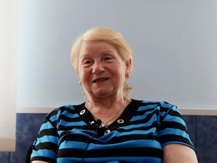 Woman wearing a blue and black striped top
