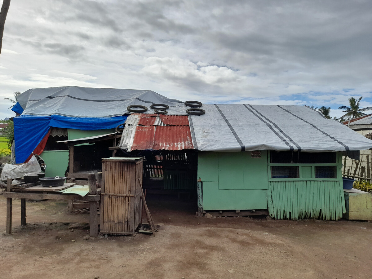 Building with the roof covered in tarpaulins