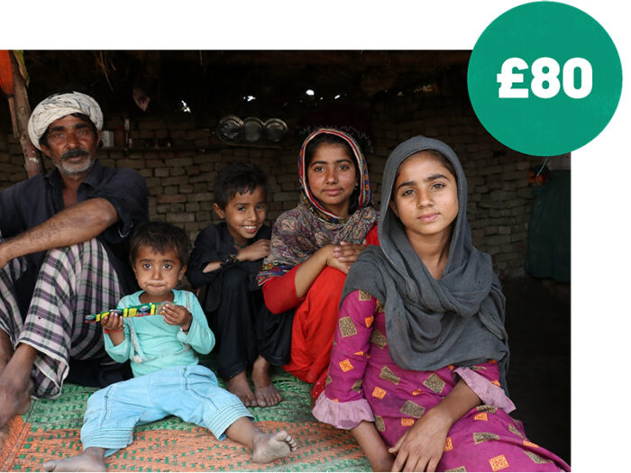 Family in Pakistan with added green circle with £80 in white inside