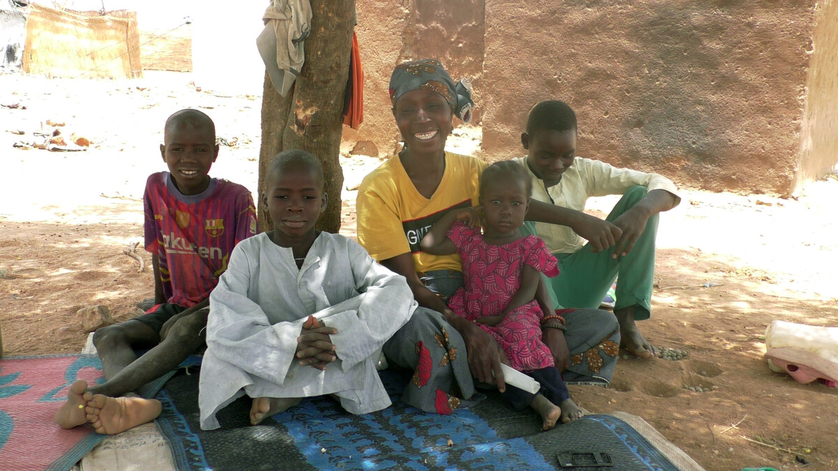 Woman and children sitting under a tree in Cameroon