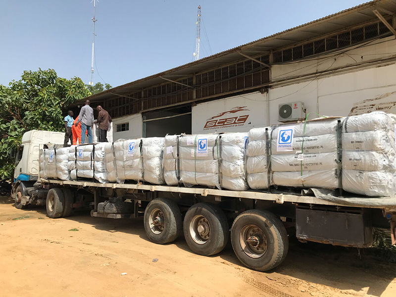 Lorry with aid parked outside a warehouse in Chad