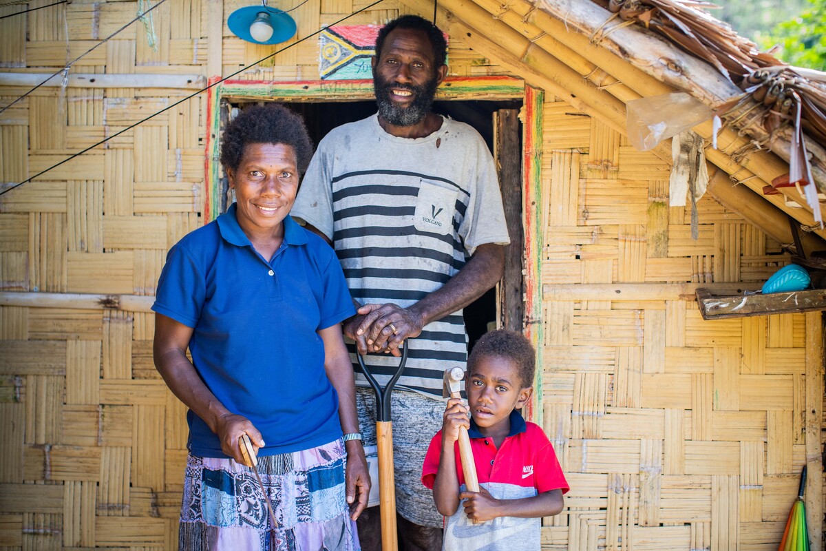Family standing outside their home in Vanuatu