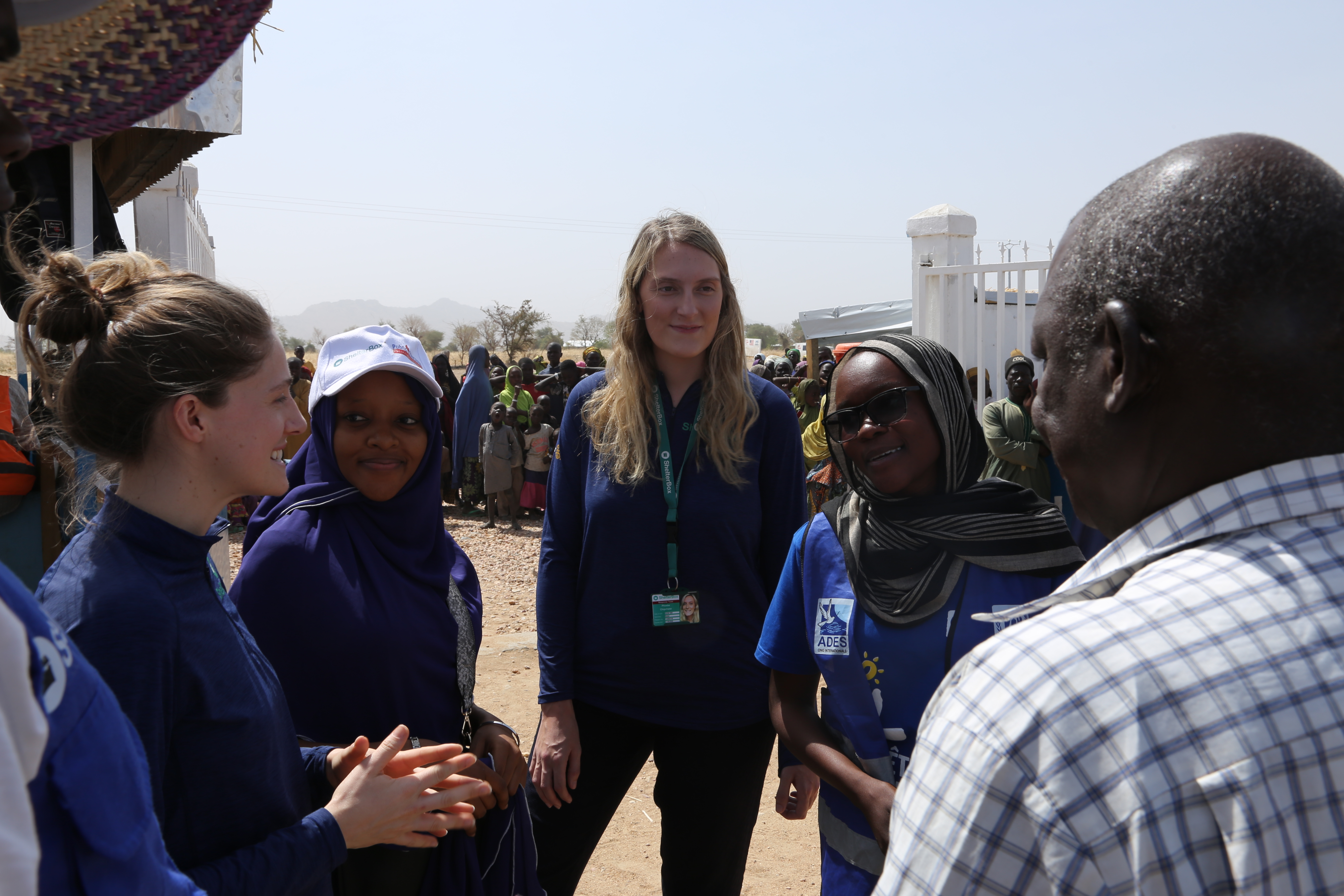 People standing and talking while on deployment as humanitarians