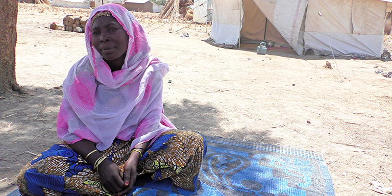 Woman sitting on the floor in Minawao Camp, Cameroon