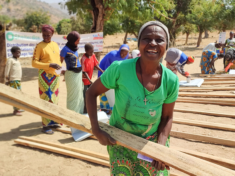 Woman carrying wood distributed as aid in Cameroon