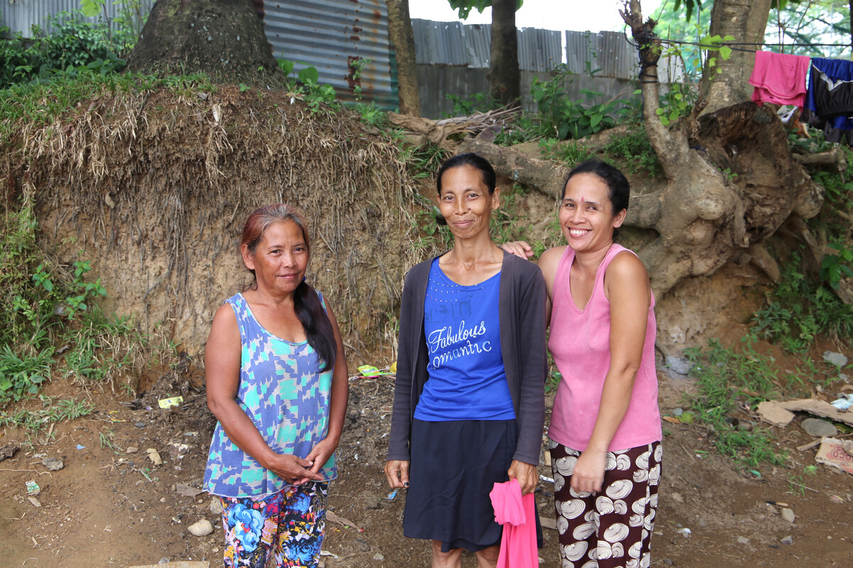 Three women in the Philippines. Tropical Storm Kai-tak destroyed all their homes.
