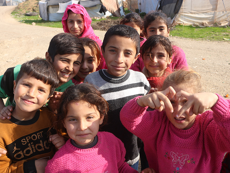 Group of children smiling at the camera in Syria