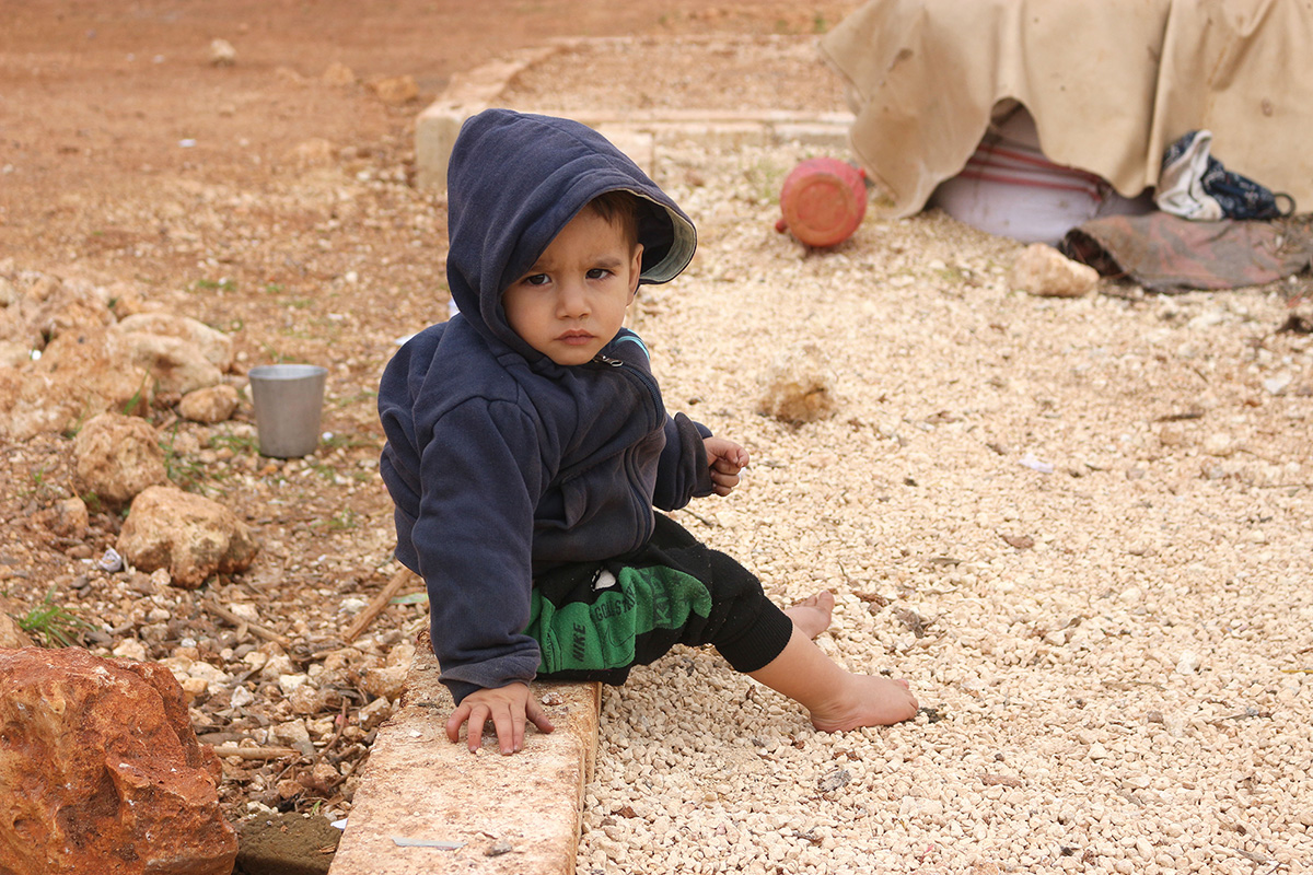 Child in a warm winter coat in Syria