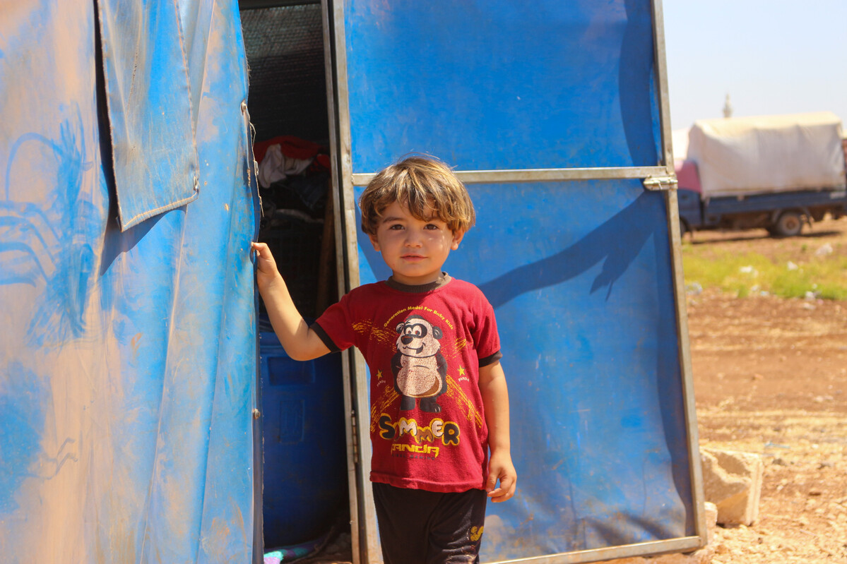 Box standing in front a tent in Syria