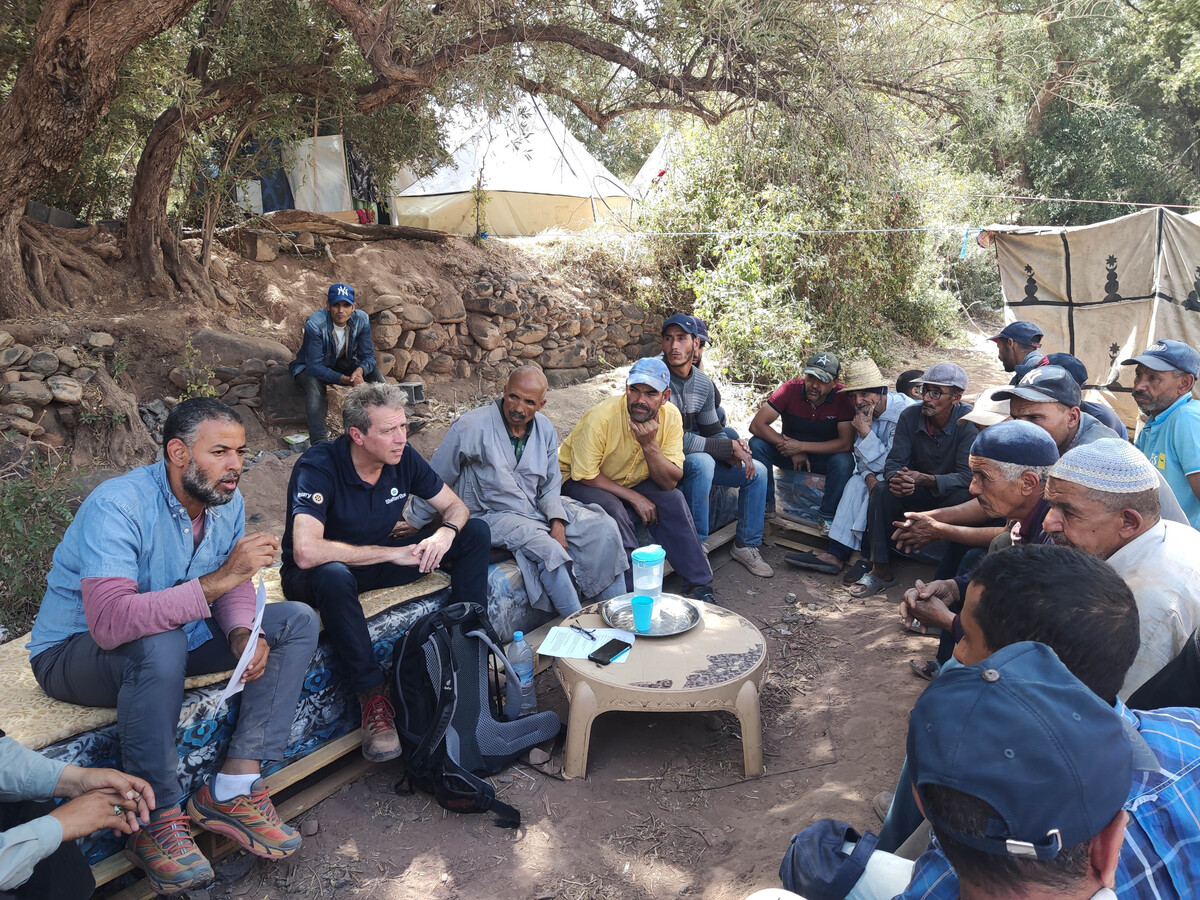 Several people sitting and talking in the Atlas Mountains in Morocco after the earthquake there