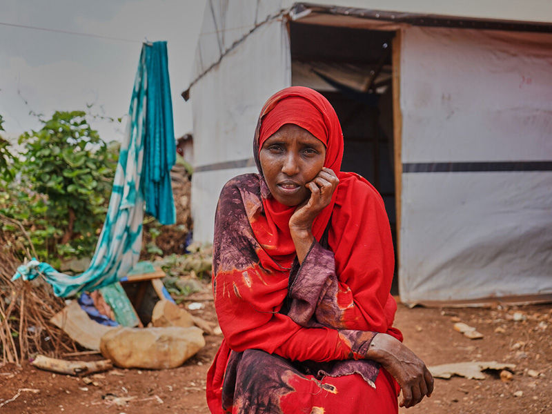 Woman sitting outside of a temporary shelter in Somalia
