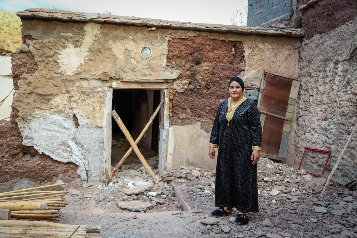 Woman standing outside a house damaged by the earthquake in Morocco