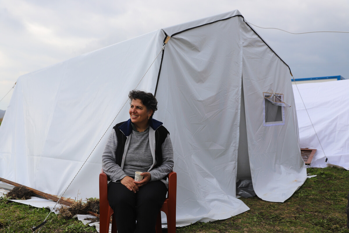 Woman sitting outside a tent in Turkey after the earthquakes