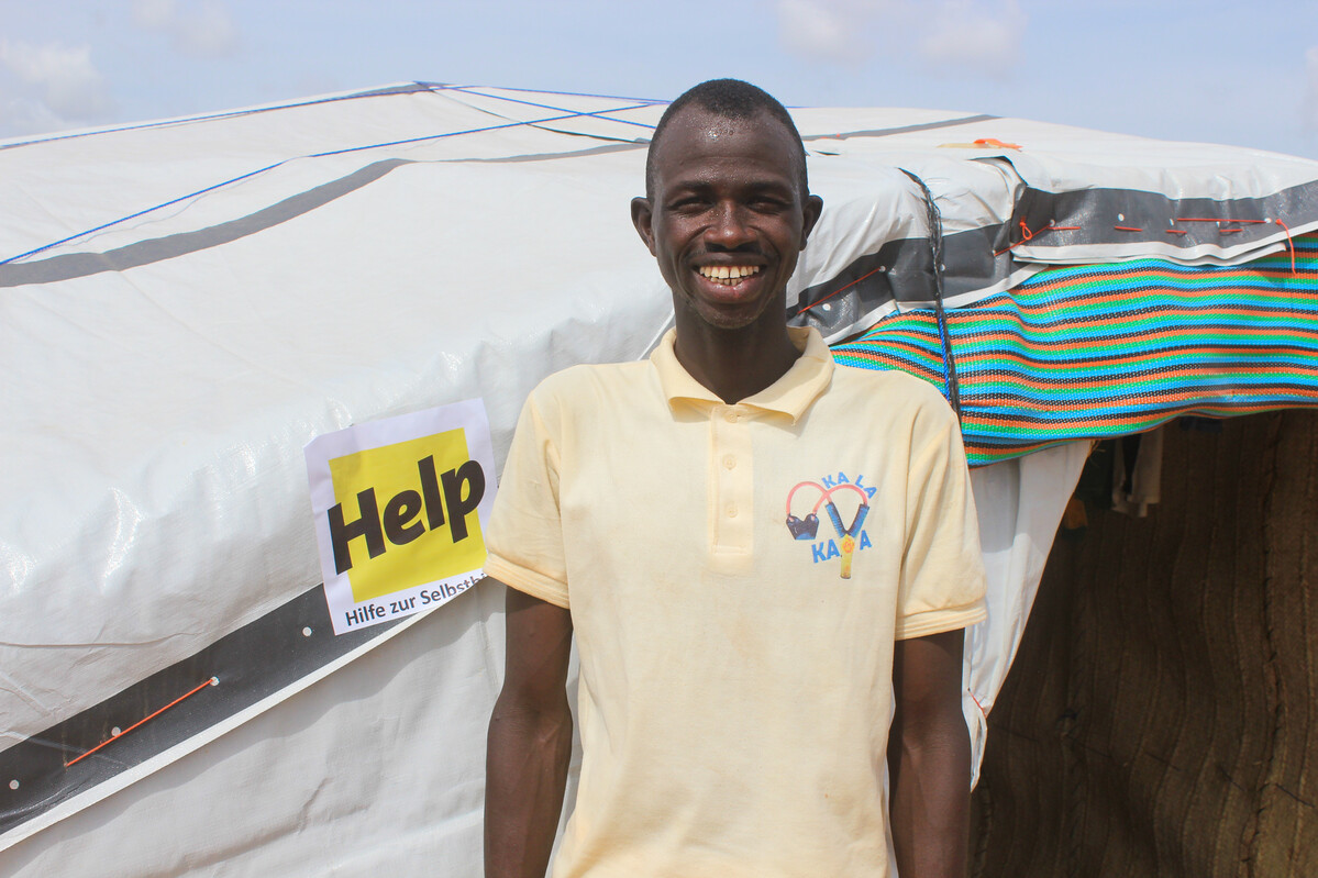Man standing outside a Sahelian tent in Burkina Fsdo