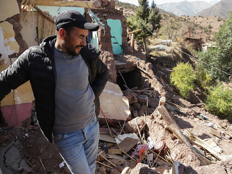 Man looking down at remains of his house destroyed in earthquake in Morocco