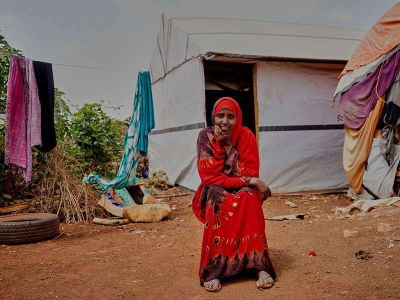 Woman sitting outside a shelter in Somalia
