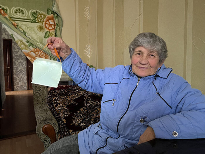 Woman in blue holding up a solar light