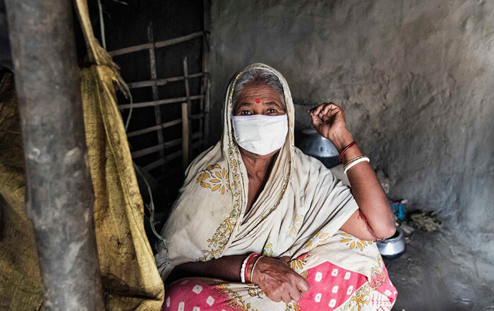 Woman wearing a face mask inside a shelter in India