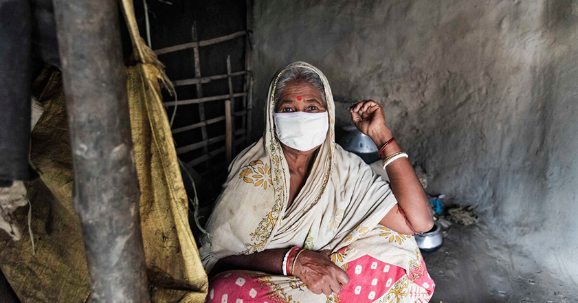Woman wearing a face mask inside a shelter in India