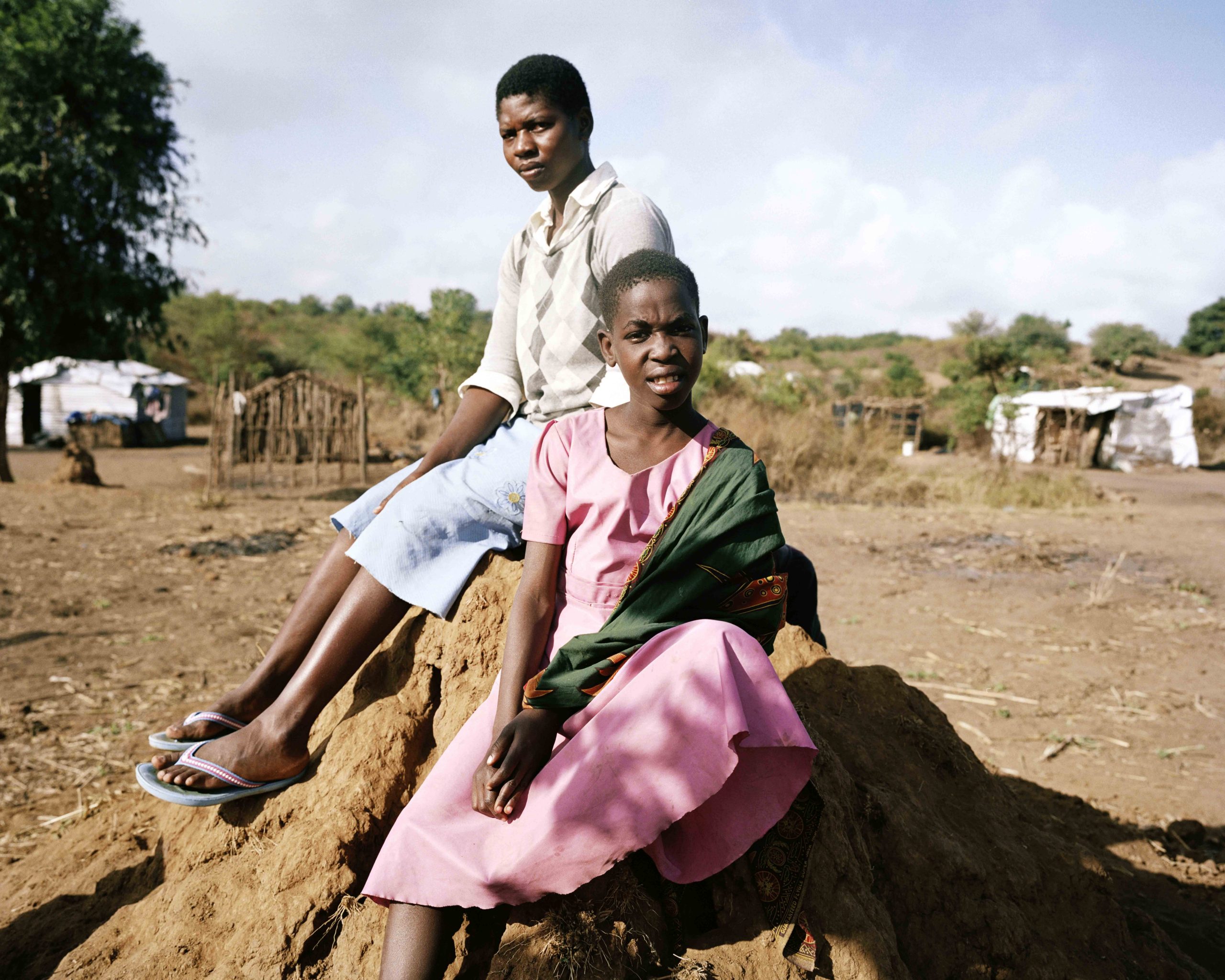 Children sitting on a termite mound in Mwalija, Malawi