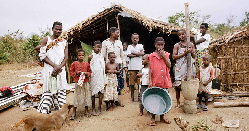 Family standing outside a home in Malawi