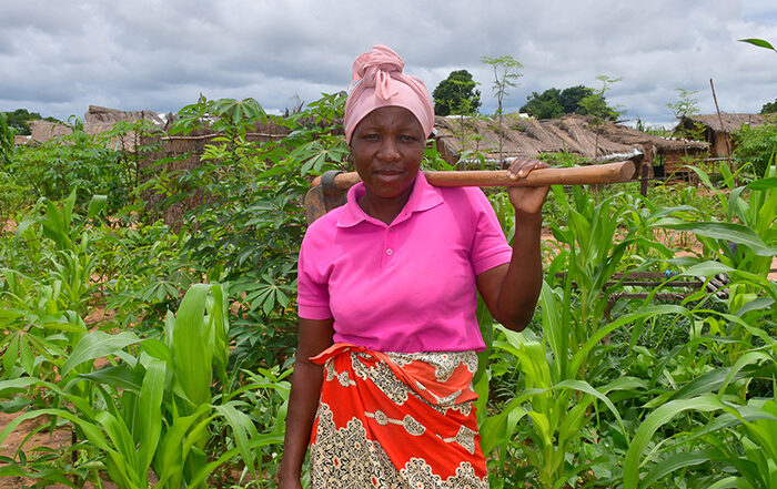 Woman holding a tool in a field in Mozambique