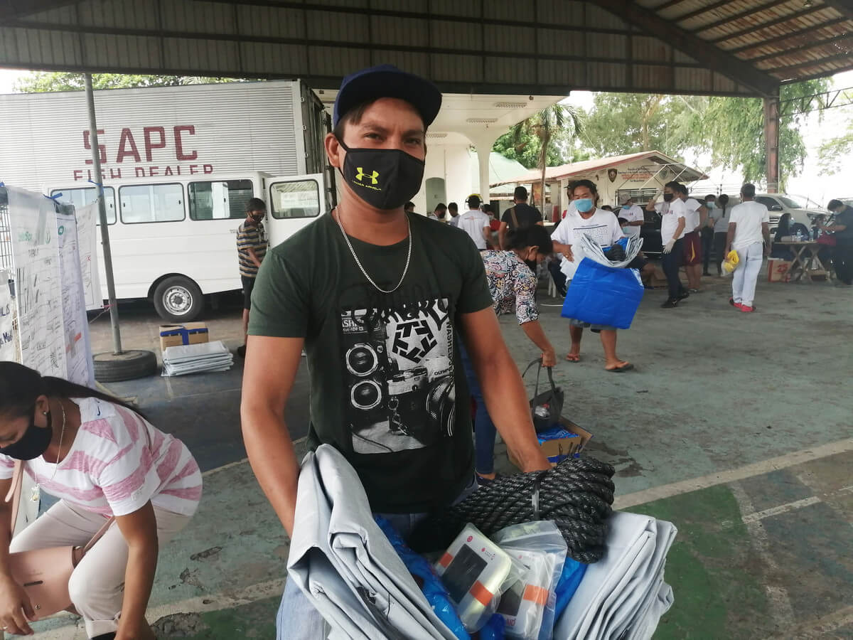 Man collects ShelterBox aid in the Philippines
