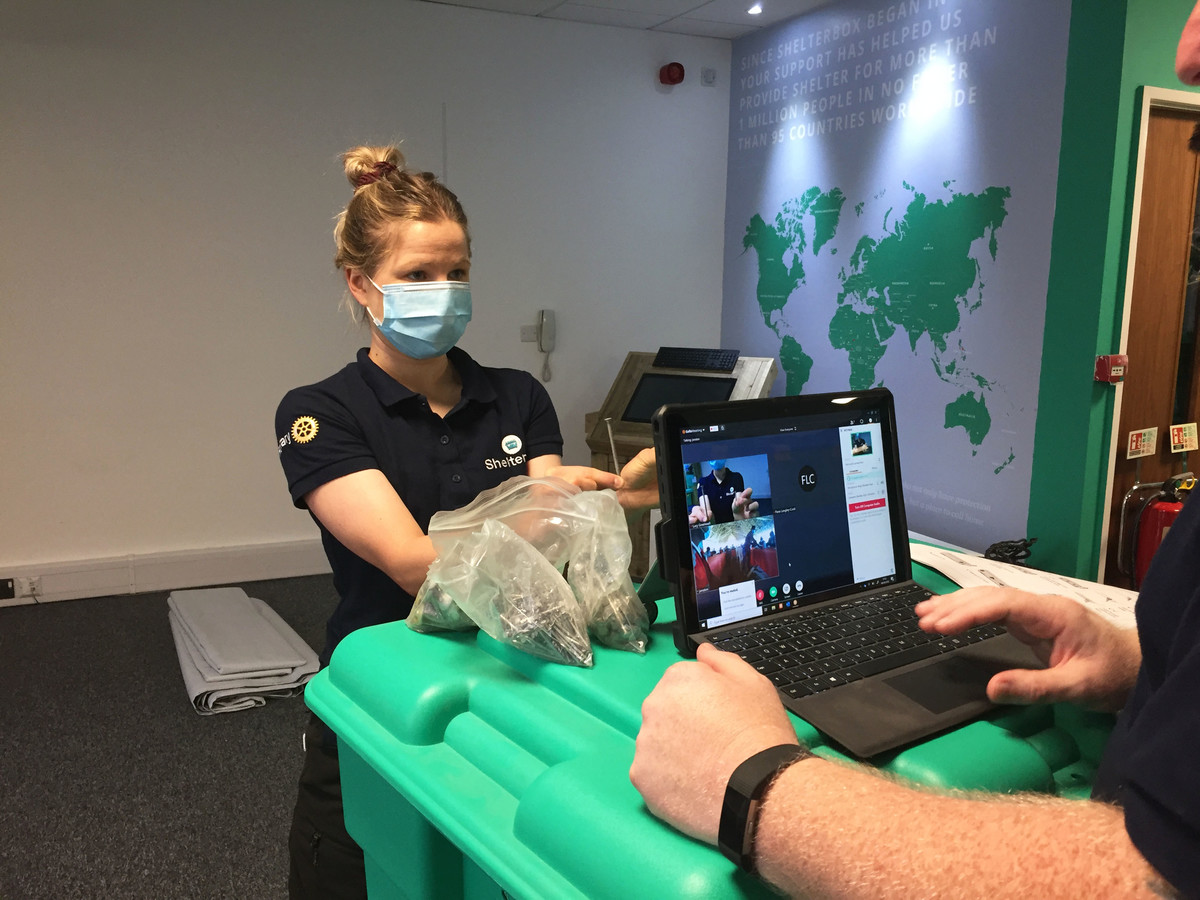 Two people demonstrating an aid item as part of remote training during coronavirus