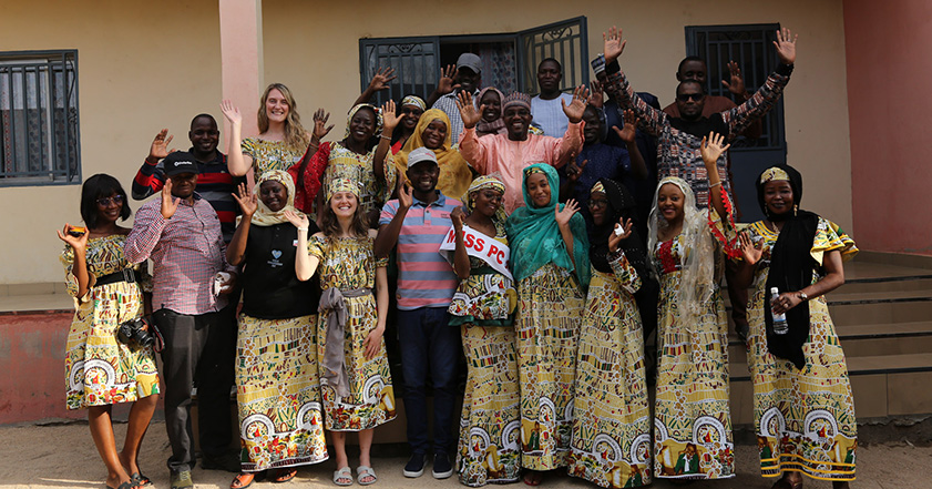 Group of people smiling and waving at the camera in Cameroon