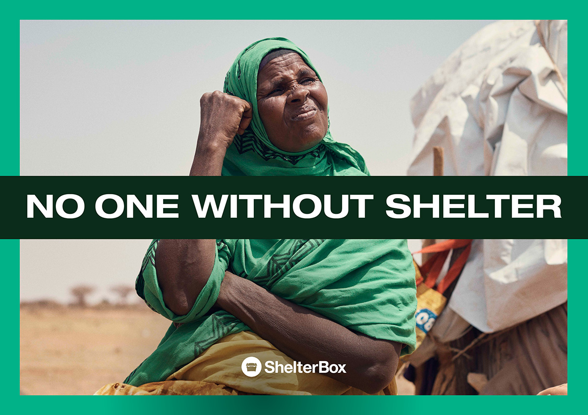 Woman in green scarf next to a tent with the words 'No one without shelter' across the middle in a dark green box