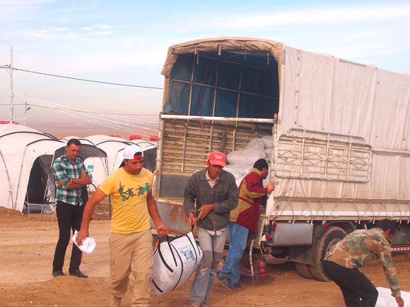 People unloading aid items from a truck