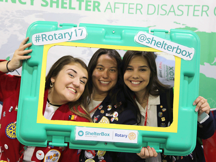 3 girls posing with a green ShelterBos frame