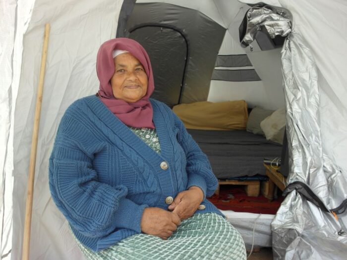 Woman sitting in the entrance of a tent in Morocco
