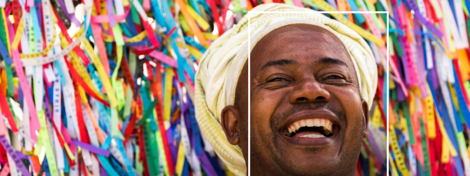 Face of man wearing turban surrounded by colourful confetti