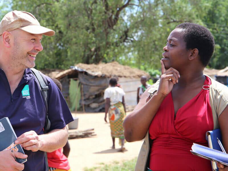 ShelterBox male staff member talking to female Habitat for Humanity staff member